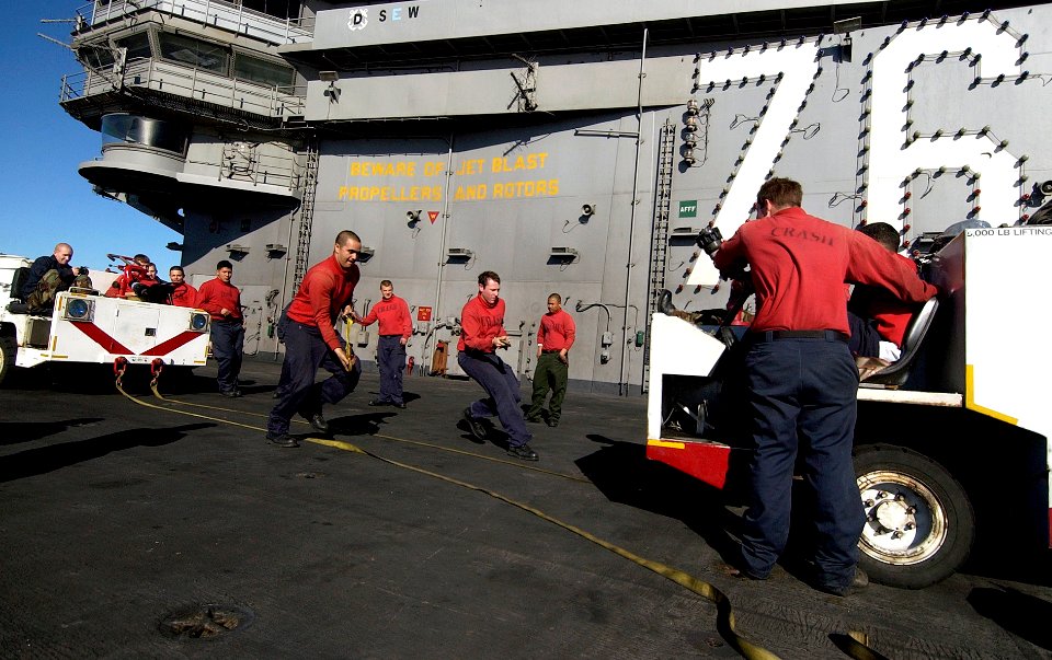US Navy 061201-N-7130B-050 During a no-fly day aboard USS Ronald Reagan (CVN 76), members of air department's crash and salvage workcenter pass the time by competing in speed drills