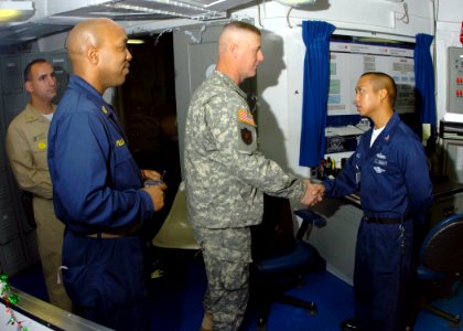 US Navy 061204-N-8907D-007 Command Sgt. Maj. Jeff Mellinger talks with Hospital Corpsman 3rd Class Bernard Morales about life aboard Nimitz-class aircraft carrier USS Dwight D. Eisenhower (CVN 69)