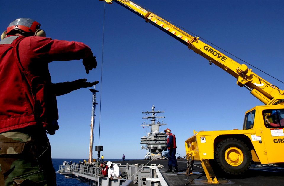 US Navy 061130-N-7130B-138 On the flight deck of USS Ronald Reagan (CVN 76), members of combat system department's CS-7 division carefully download NATO AIM-7 Sea Sparrow missiles in preparation for an upcoming ammunition