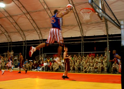 US Navy 061208-N-1328C-530 Elgrace Wilborn, member of the Harlem Globetrotters, dunks the basketball during his performance at Camp Lemonier, home of the Combined Joint Task Force - Horn of Africa (CJTF-HOA) command