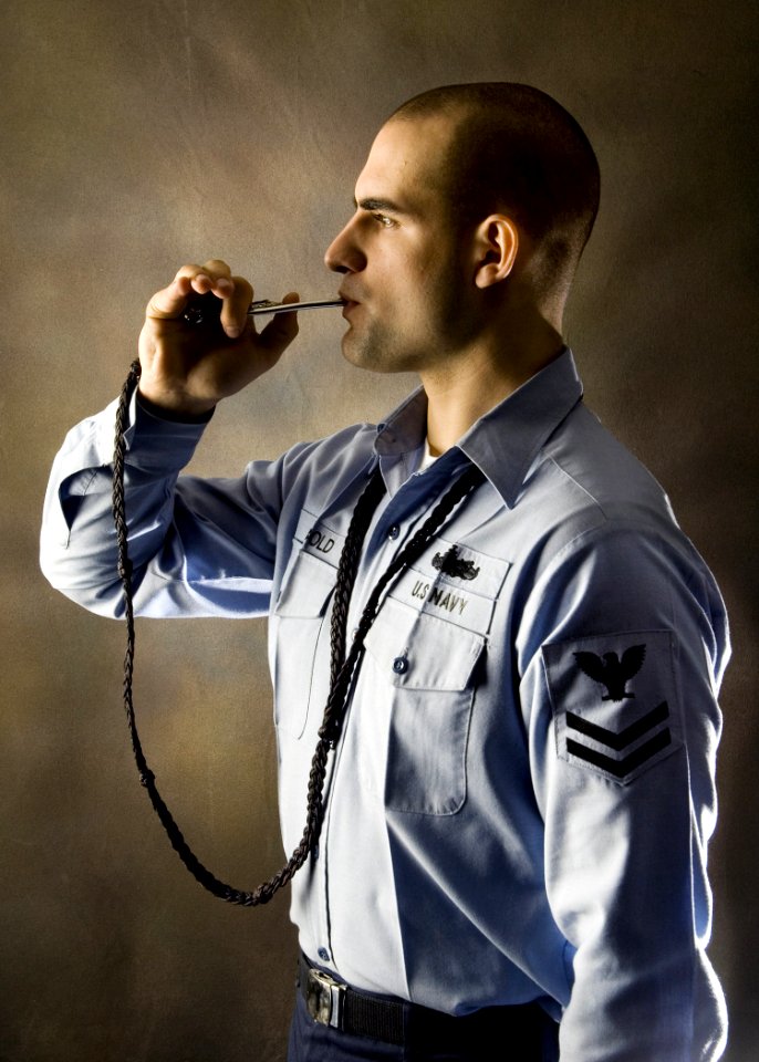 US Navy 061204-N-9446C-001 A portrait of Boatswain's Mate 2nd Class Kevin Diebold, assigned to deck department, aboard the Nimitz-Class aircraft carrier USS Carl Vinson (CVN 70) holding his Boatswain's Pipe