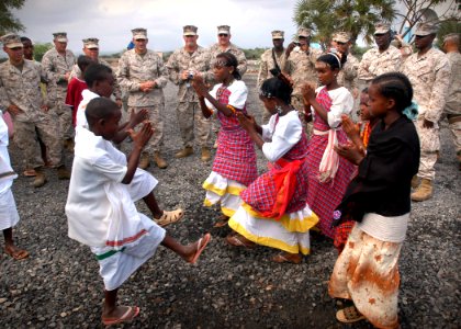 US Navy 061205-N-1328C-530 U.S. Marines assigned to the 5th Provisional Security Company watch a dance performed by students of the Douda Primary School