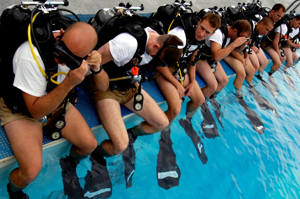 US Navy 061206-G-3721C-769 Students at the Naval Diving and Salvage Training Center prepare to dive in a 12-foot pool for training
