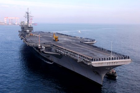 US Navy 061210-N-8591H-107 Sailors man the rails of USS Kitty Hawk (CV 63) as the ship pulls into Truman Bay, Yokosuka, Japan following a 56-day winter underway period which included port calls to Sasebo and Hong Kong