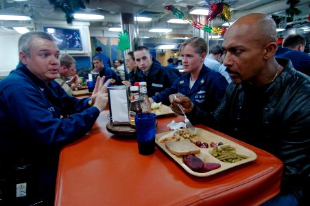US Navy 061205-N-8148A-039 Cryptologic Technician 2nd Class Brian Heckel, from St. Louis, speaks with Montel Williams during his visit to guided missile destroyer USS Howard (DDG 83)