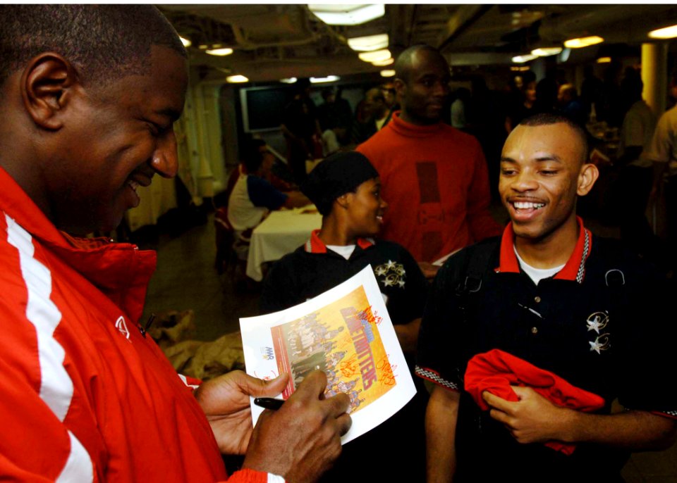 US Navy 061211-N-5330L-007 Paul Showtime Gaffney, the master showman of the Harlem Globetrotters, signs autographs for Sailors aboard Nimitz-class aircraft carrier USS Dwight D. Eisenhower (CVN 69) during a meet and greet