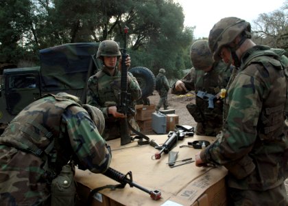 US Navy 061206-N-3560G-009 Members of Naval Mobile Construction Battalion Four (NMCB-4) fieldstrip and clean their M16-A service rifle during field exercise Operation Bearing Duel