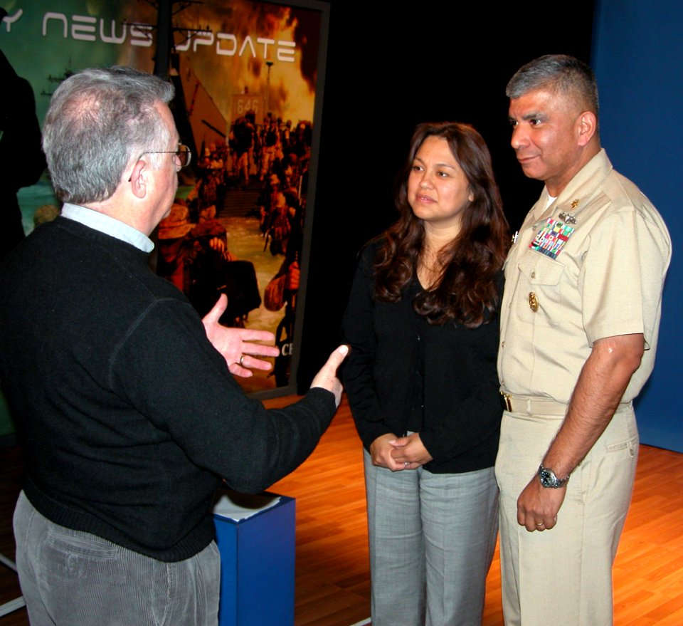 US Navy 061206-N-2529H-003 Master Chief Petty Officer of the Navy (MCPON) Joe R. Campa Jr. and his wife Diana receive instructions from Naval Media Center producer John Morrissey prior to taping a holiday greeting to the fleet