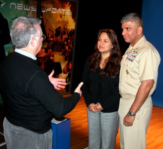 US Navy 061206-N-2529H-003 Master Chief Petty Officer of the Navy (MCPON) Joe R. Campa Jr. and his wife Diana receive instructions from Naval Media Center producer John Morrissey prior to taping a holiday greeting to the fleet photo