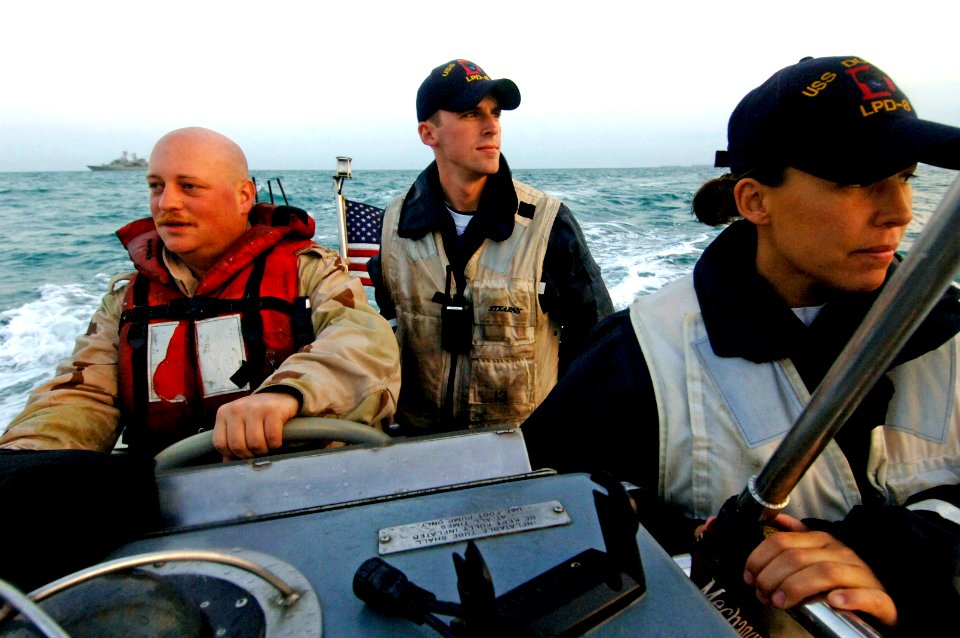 US Navy 061206-N-8148A-145 Coxswain, Boatswain's Mate 2nd Class Chris Covert, boat officer, Ensign Patrick Gillen, and boat officer, Ensign Janet Broome from amphibious transport dock USS Dubuque (LPD 8) deliver passenger