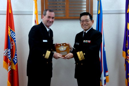 US Navy 061205-N-3333K-001 Rear Adm. Raymond Berube, commander, Fleet and Industrial Supply Centers (COMFISCS), accepts a plaque from Vice Adm. Yosinori Kawano, commander of the Maritime Materiel Command, Japan Maritime Self De