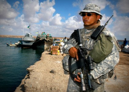 US Navy 061209-N-1328C-369 Spc. Phillip Escribano, from Dededo, Guam, stands perimeter watch at the Obock pier, during a distinguished visitor's visit. Ray's home unit is the Guam National Guard and is currently attached to Com