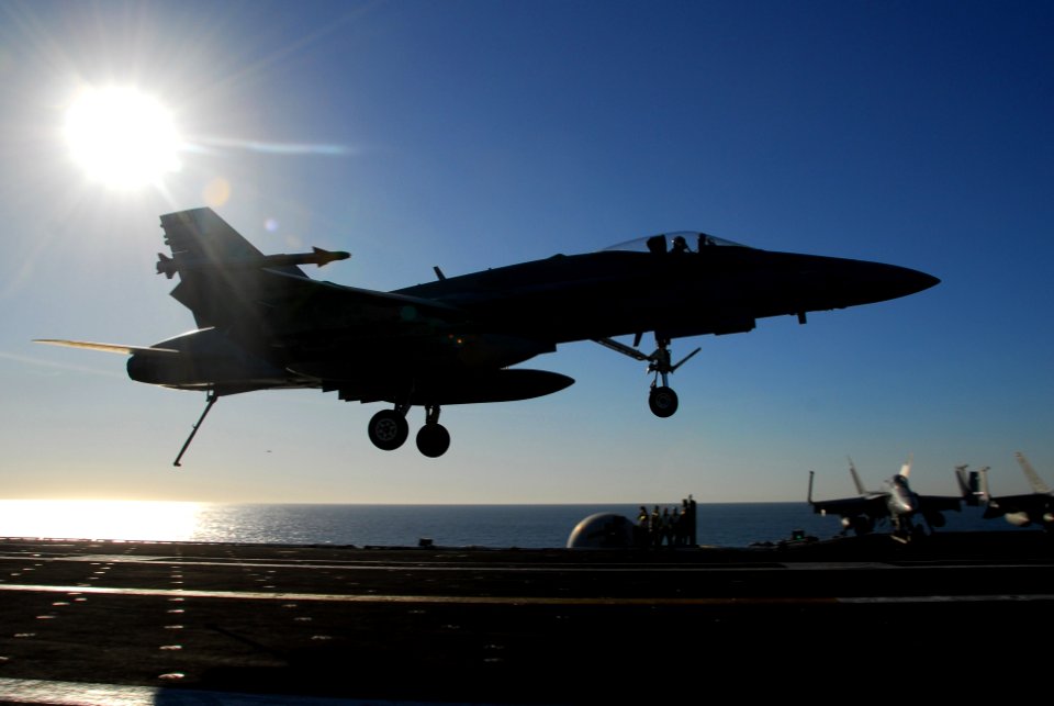 US Navy 061204-N-8158F-221 An F-A-18 Hornet assigned to Strike Fighter Squadron Eight One (VFA-81) prepares to make an arrested landing on the flight deck aboard the nuclear-powered aircraft carrier USS Nimitz (CVN 68)