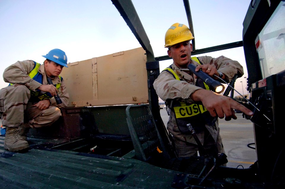 US Navy 061209-N-8148A-038 Customs Border Clearance Agent Boatswain's Mate 3rd Class Ryan Koney, right, points out clumps of missed dirt to Customs Border Clearance Agent Quartermaster 3rd Class Christian Moreno during a qualit