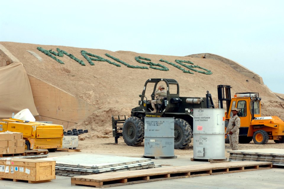 US Navy 061216-N-5758H-018 Storekeeper 3rd Class Paul Baillos, assigned to the Mobile Air Cargo Handling (MACH) VI Team, prepares to operate a 10K fork lift to transport cargo off a flat bed truck