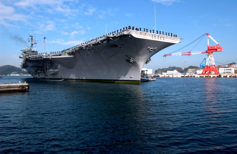 US Navy 061210-N-9851B-003 Sailors man the rails as USS Kitty Hawk (CV 63) pulls into forward deployed operating base, Commander Fleet Activities Yokosuka
