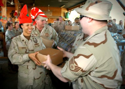 US Navy 061210-N-1328C-084 Southwest Asia 1st Class Petty Officer's Association's president, Master-at-Arms 1st Class Malika Derios hands out Christmas gifts to service members from Camp Lemonier and Combined Joint Task Force