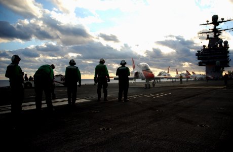US Navy 061211-N-7241L-009 Flight deck personnel wait as a T-45 Goshawk taxis to the catapult during carrier qualifications aboard USS Theodore Roosevelt (CVN 71)