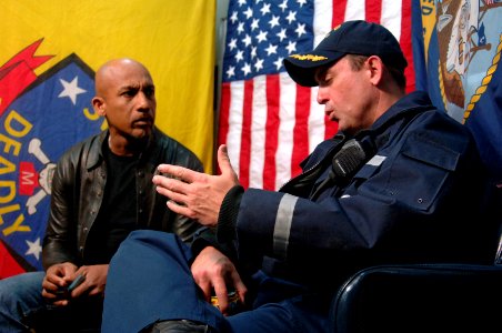 US Navy 061205-N-8148A-078 Cmdr. James Morgan, commanding officer aboard guided-missile destroyer USS Howard (DDG 83), speaks with Montel Williams aboard the ship