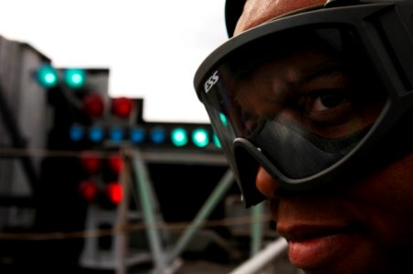 US Navy 061205-N-8591H-060 Interior Communications Electrician 3rd Class Michael Reid observes flight operations from the flight deck of USS Kitty Hawk (CV 63)