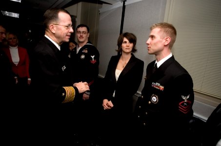 US Navy 061212-N-0696M-010 Chief of Naval Operations (CNO) Adm. Mike Mullen speaks with Chief Cryptologic Technician (Collection) Brian Davidson and and his wife during a ceremony recognizing his selection as Recruiter of the Y