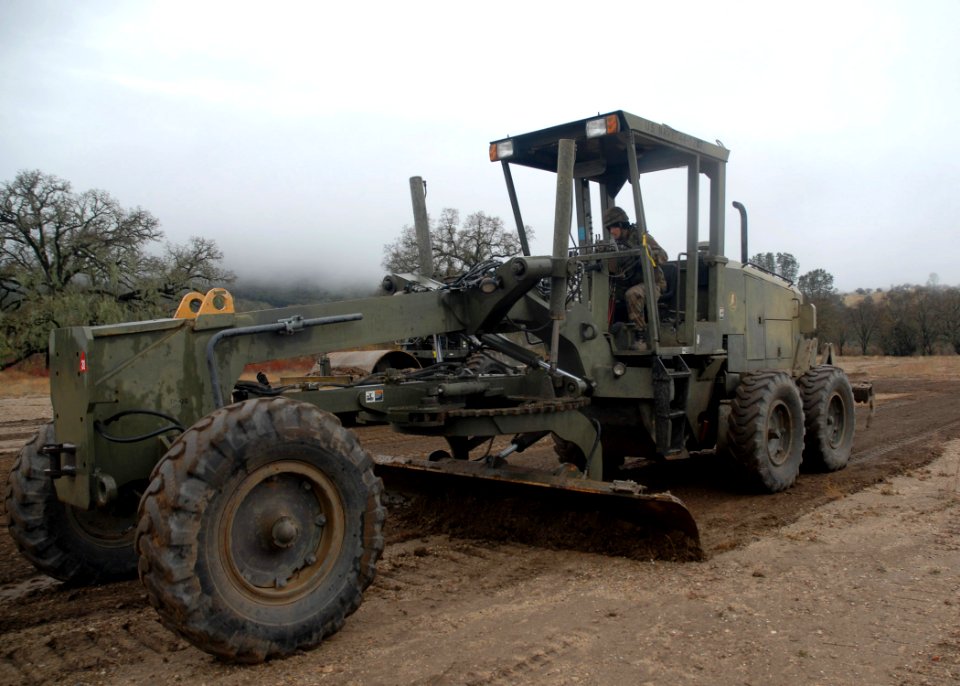 US Navy 061212-N-3560G-045 Equipment Operator 3rd Class Hyden Coleman of Naval Mobile Construction Battalion Four (NMCB-4) operates a grader during the Rapid Runway Repair (RRR) exercise during the field exercise Operation Bear