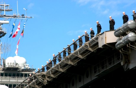 US Navy 061210-N-9851B-004 Sailors man the rails as USS Kitty Hawk (CV 63) pulls into forward deployed operating base, Commander Fleet Activities Yokosuka