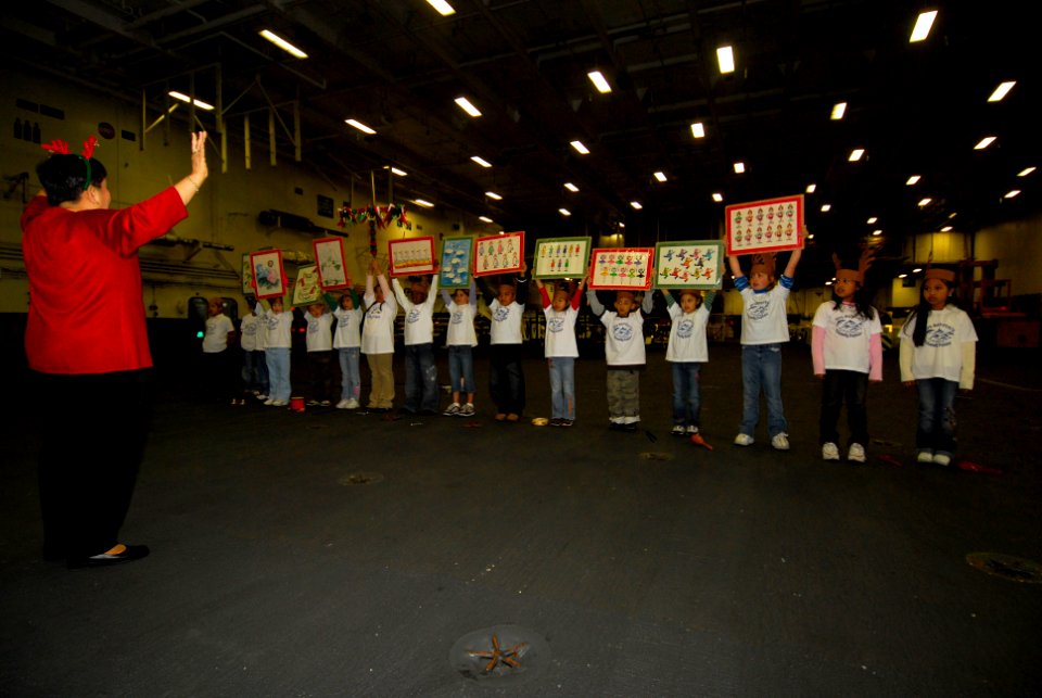 US Navy 061219-N-6106R-083 Children from The Sullivans Elementary School at Fleet Activities Yokosuka, perform the 12 Days of Christmas for USS Kitty Hawk (CV 63) crew members