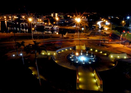 US Navy 061220-N-4965F-001 The Pearl Harbor Memorial fountain illuminates the night as holiday lights shine from the Ticonderoga-class guided-missile cruiser USS Lake Erie (CG 70)