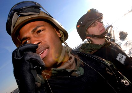 US Navy 061220-N-5345W-074 Air Traffic Controller 3rd Class Gregory Wilson calls in an unidentified surface contact to security while Information Systems Technician 3rd Class Benjamin Pierce keeps a lookout from his M-240 machi