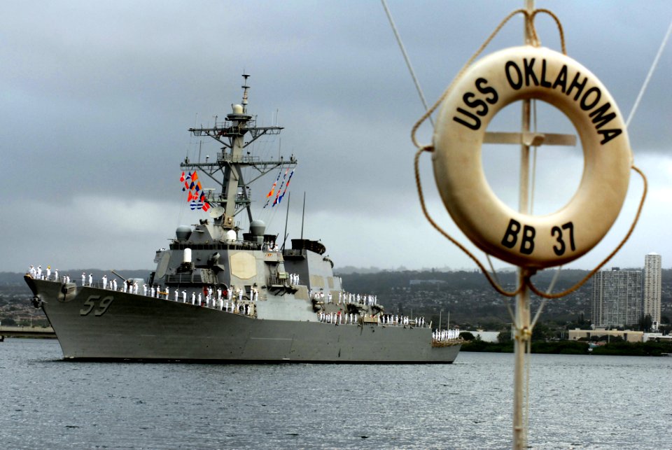US Navy 061207-N-4965F-009 Sailors assigned to the Arleigh-Burke class guided-missile destroyer USS Russell (DDG 59) render honors to the USS Arizona Memorial and Pearl Harbor survivors as they perform a Pass-in-Review