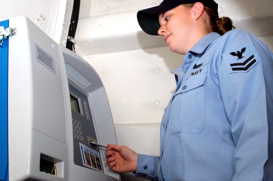 US Navy 061212-N-7498L-051 Operations Specialist 2nd Class Catherine Goforth uses the Navy cash card for the first time aboard dock landing ship USS Georgetown (LSD 42)