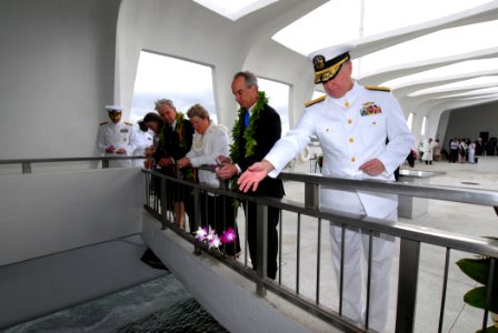 US Navy 061207-N-4965F-070 Commander, U.S. Pacific Fleet Adm. Gary Roughead, throws flower pedals into the USS Arizona Memorial well during a floral tribute at the memorial