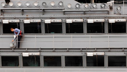 US Navy 061221-N-5345W-035 Airman Brian Harris carefully cleans the windows on the island structure of the Nimitz-class aircraft carrier USS Harry S. Truman (CVN 75)