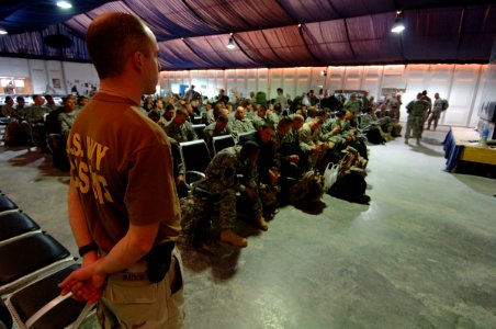 US Navy 061223-N-5758H-062 Operations Specialist 3rd Class Joseph Watson, assigned to Navy Customs Battalion Romeo, prepares to brief troops redeploying about items that are prohibited