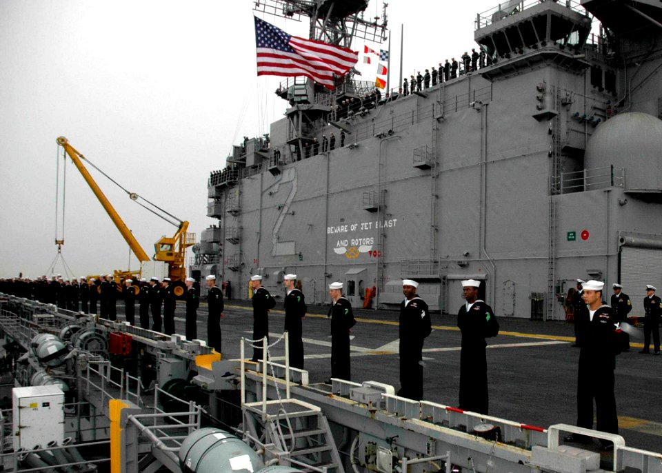 US Navy 061222-N-8547M-005 Sailors aboard the amphibious assault ship USS Saipan (LHA 2) man the rails as she pulls in to her homeport of Norfolk, after successfully completing the last surge deployment of her 29-year career