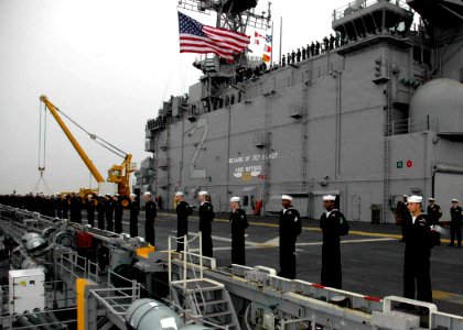 US Navy 061222-N-8547M-005 Sailors aboard the amphibious assault ship USS Saipan (LHA 2) man the rails as she pulls in to her homeport of Norfolk, after successfully completing the last surge deployment of her 29-year career