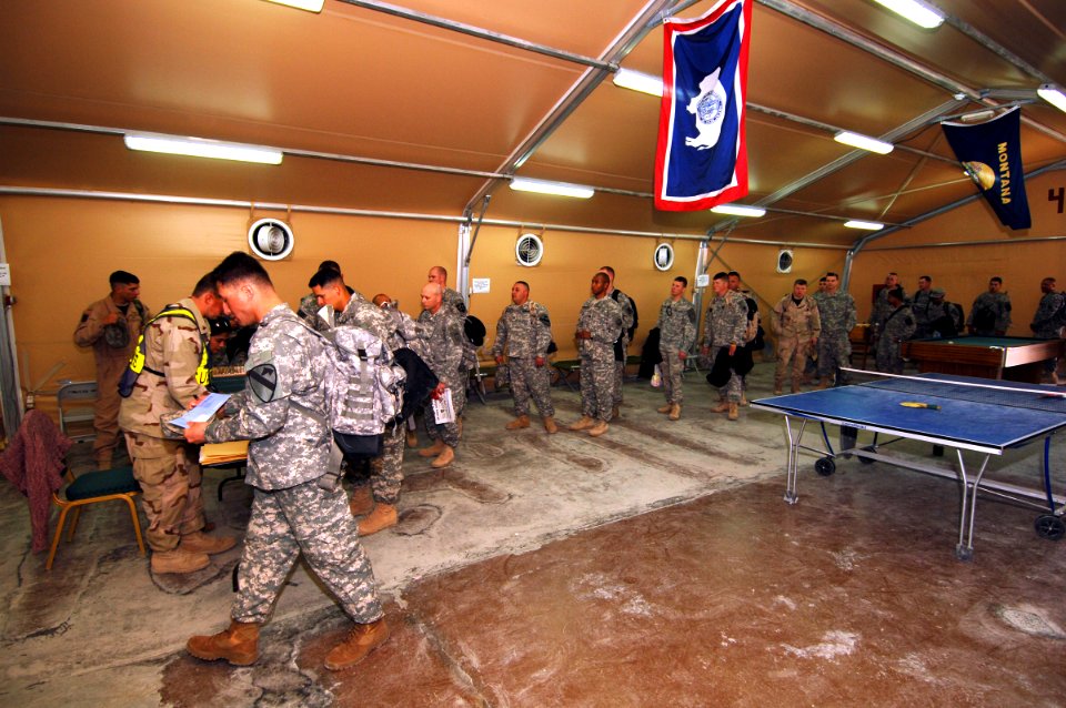 US Navy 061223-N-5758H-221 After clearing customs inspection, American troops receive their tickets and itineraries for their trip back to America at an air base in Southwest Asia