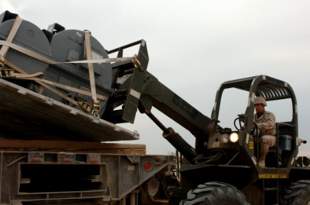 US Navy 061216-N-5758H-059 Storekeeper 3rd Class Paul Baillos, assigned to the Mobile Air Cargo Handling (MACH) VI Team, operates a 10k fork lift to transport cargo