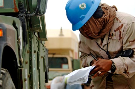 US Navy 061216-N-8148A-009 Boatswain's Mate 3rd Class Victoria Davis, assigned to Navy Cargo Handling Battalion Four (NCHB-4), inspects military vehicles prior to loading them on board Military Sealift Command (MSC) roll-on-rol