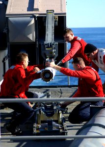 US Navy 061210-N-7241L-004 Aboard the Nimitz-class aircraft carrier USS Theodore Roosevelt (CVN 71) fire controlmen work to off-load AIM-7 NATO Sea Sparrow missiles from one of the ship's launchers