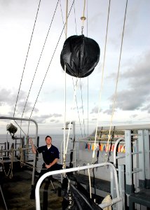 US Navy 061210-N-8547M-011 Quartermaster Seaman Jeff Schulze raises the circle-diamond-circle aboard the amphibious assault ship USS Saipan (LHA 2)