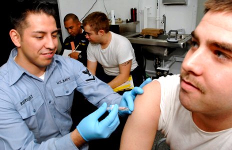 US Navy 061218-N-5345W-053 Hospital Corpsman 3rd Class Ramon Rodriguez administers a typhoid vaccination during an annual checkup aboard the Nimitz-class aircraft carrier USS Harry S. Truman (CVN 75)