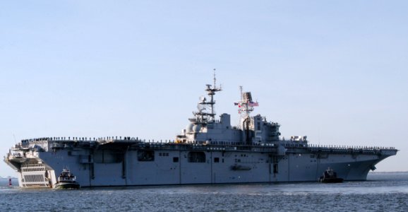US Navy 070104-N-1713L-103 Sailors and Marines man the rails as the amphibious assault ship USS Bataan (LHD 5) departs Naval Station Norfolk