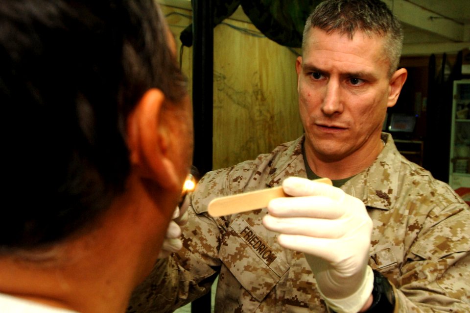 US Navy 061220-N-5758H-028 Lt. Cmdr Thomas Friedrich, assigned to the 1st Medical Battalion, Camp Pendleton, performs a medical evaluation on an Iraqi citizen