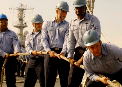 US Navy 061222-N-5330L-186 Line handlers aboard the guided-missile cruiser USS Anzio (CG 68) wait for the signal to heave the mooring line as Anzio moors into port at United Arab Emirates