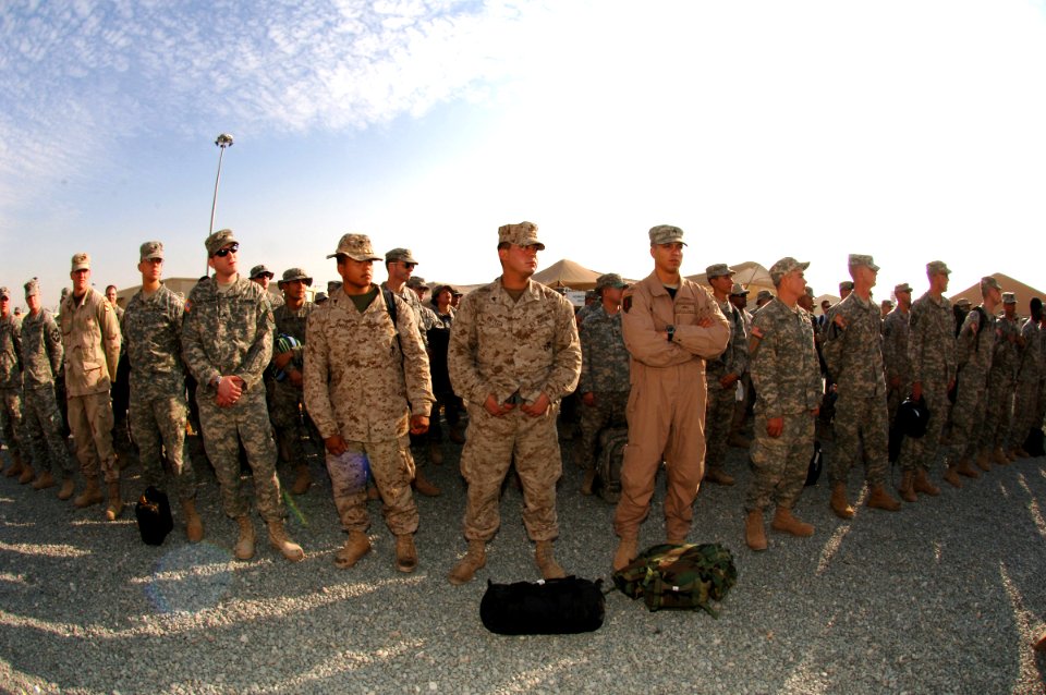 US Navy 061223-N-5758H-265 After customs inspection, American troops listen up for roll call muster to ensure everyone is present and accounted for at an air base in Southwest Asia, prior to departing for the airport