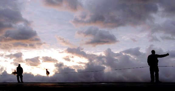 US Navy 061221-N-5345W-007 Air department Sailors assigned to the launch and recovery division aboard Nimitz-class aircraft carrier USS Harry S. Truman (CVN 75) watch as a large cloud of steam rises towards the sky during no-lo