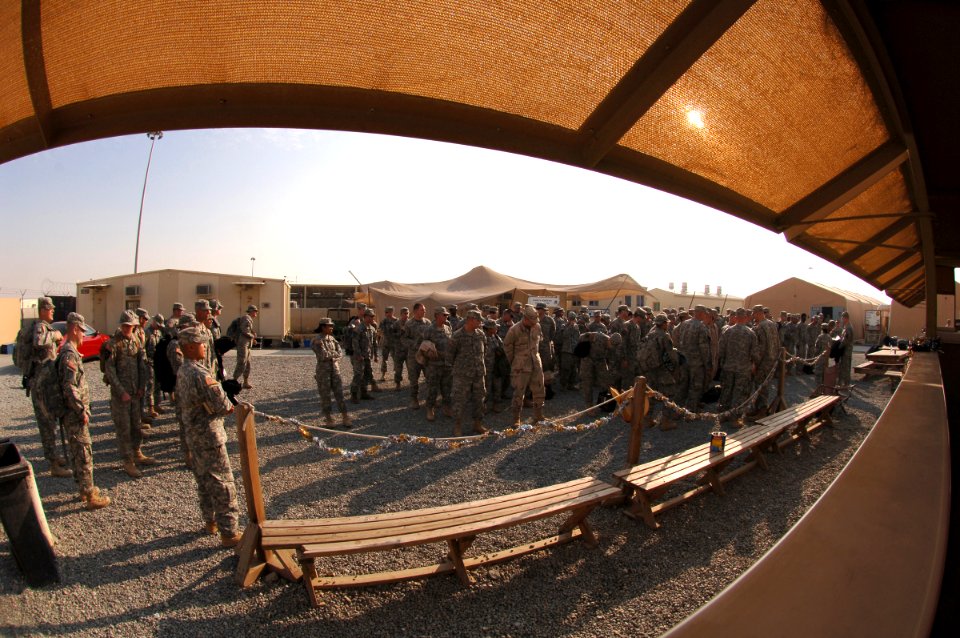 US Navy 061223-N-5758H-280 After customs inspection, American troops listen up for roll call muster to ensure everyone is present and accounted for at an air base in Southwest Asia, prior to departing for the airport