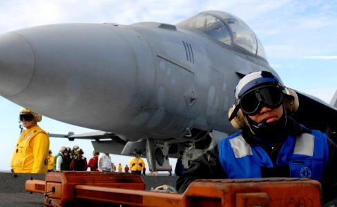 US Navy 070113-N-5345W-030 An air department tractor driver waits for the command to move an F-A-18F Super Hornet assigned to the Red Rippers of Strike Fighter Squadron One One (VFA-11) into position on the flight deck